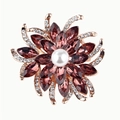 Fashion flower brooch in rose gold with purple crystals and central pearl on white background - Burgundy