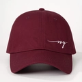 Detailed close-up of wine red cotton baseball cap with white NY embroidery and eyelets - One Size / Burgundy