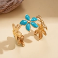Detail of gold floral open bangle with blue enamel petals on a textured sand base - Bracelet - Blue - Small Flower