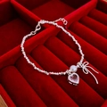 Macro shot of silver beaded necklace with pink heart gem, pearl, and bow charm detail - Heart Bowknot Bracelet