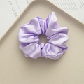 Elegant purple satin scrunchie with smooth silk texture on a ceramic tray - Light Purple