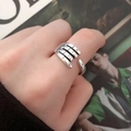Close-up of a silver hugging hands open ring showing detailed craftsmanship and texture - Style 008 Handshake / Silver