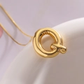 Golden balloon style letter Q pendant necklace with thin chain on ceramic edge - Letter Q