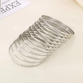 Set of ten stackable slim stainless steel bangles with a polished silver finish - Inner Diameter 55mm / 12 Rings / Steel