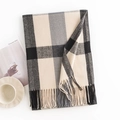 Soft black grey and beige plaid scarf with tassels styled on a minimalist background - Dark Gray