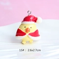 Detail view of a yellow resin Christmas bird charm with Santa hat and dimensions 2.6x2.7cm - Style 15-Chicken in Santa Outfit