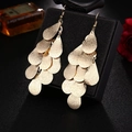 Detail of gold multilayered teardrop tassel earrings on black jewelry display stand - S4303-1 Multi-layer Teardrop