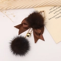 Brown faux fur pompom keychain with ribbon bow and golden bell on textured fabric - Brown