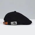 Detail of black canvas ivy cap featuring brown leather strap and silver metal buckle - Black