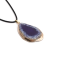 Detail of violet agate pendant with gold-plated edges on a black wax cord necklace - Purple