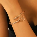 Close-up of golden heart-shaped wire wrap bracelet on wrist with elegant hollow design - Gold Heart Wire Wrapped (H-75)