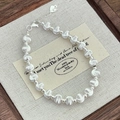 Macro shot of S925 sterling silver beaded bracelet with heart charm and lobster clasp - 925 Silver / 6mm Style