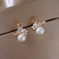 Chic golden bird stud earrings featuring white pearls and sparkling pavé crystals - Bird Flower Pearl / Gold