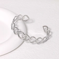 Minimalist silver stainless steel open cuff bracelet featuring heart-shaped cutout design - Steel