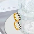 Elegant gold checkerboard ring with black and white enamel on a reflective surface - US 7 / Gold