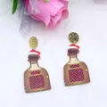 Christmas wine bottle earrings with red plaid and Santa hat on plush white background - Wine Bottle
