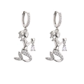 Detailed macro view of silver mermaid earrings featuring crystal heart and pear-shaped drops - Silver Mermaid