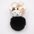 Detailed view of lucky cat plush keychain featuring a fluffy black faux fur pompom ball - Gold Buckle Cat / Black