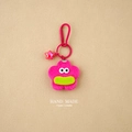 Close-up of pink plush flower keychain with large eyes and metal star charm detail - Rose Red