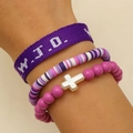 Detailed close-up of pink and purple WWJD bracelets with cross pendant and beaded charms - Purple (DZ-597)