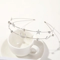 Detail shot of silver double-layered headband featuring star and moon charms with rhinestones - Metal Headband-Star & Moon Silver