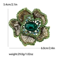 Spilla fiore in lega dorata con strass verdi e una grande pietra centrale verde smeraldo - Verde