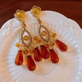 Macro detail of vintage gold-plated heart pearl earrings with amber crystal beads on ceramic - Yellow Flower Amber Bead Earrings (18#)