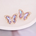 Macro shot of gradient butterfly stud earrings with colorful crystals and gold trim - Light Purple