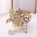 Detail of a straw crossbody bag for kids with floral bow and cotton rope strap - One Size / Beige Bag