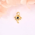 Detailed macro of gold palm tree charm with blue zircon for DIY jewelry accessories - Deep Blue Stone