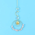 Detail of celestial suncatcher with crescent moon and pink irregular crystal stones - Rose Quartz