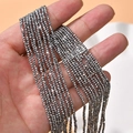 Macro shot of 2mm dark grey faceted crystal glass beads for DIY jewelry making - Silver