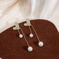 Elegant gold heart earrings with sparkling crystals and long white pearl tassels - Heart Pearl Tassel Studs