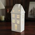 White ceramic Christmas house with star cutouts and warm glowing light decoration - Model C - House