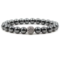 Close-up of natural hematite bead bracelet with a crystal-studded charm on white background - Silver Black Diamond Ball