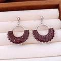 Detailed shot of silver-tone hoop earrings with deep red leather and tiny bead accents - Burgundy