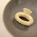 Beige acetate geometric oval hair claw clip with France Handmade text in a grey bowl - Beige