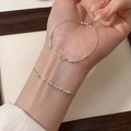 Detailed view of a minimalist silver beaded chain bracelet worn on a woman's wrist - Silver Fine Chain Multi-Row Bead (MY35237)