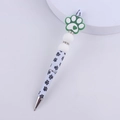 Detail of beaded pen featuring green silicone paw charm and black paw prints on white barrel - Dog Paw Green