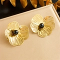 Elegant gold flower earrings with hollow petals and black pearl centers on a textured surface - Pair of Stud Earrings-Black Bead (E6103)
