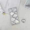 Detail of silver quilted PU leather glasses pouch with a blue heart button closure - Diamond Grid Silver
