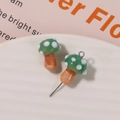 Close-up of green glass mushroom charms with white polka dots for DIY jewelry making - No.8 (Green Cap White Dot Brown Stem)