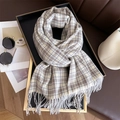 Detail of beige and brown plaid cashmere-like scarf with fringe texture on a black tray - 200x66cm / Brown and Blue