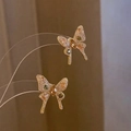 Detailaufnahme der Schleifen-Ohrstecker mit rosa und grünen Zirkonia-Steinen in Gold - Gold