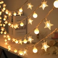 Solar powered star and globe LED string lights with warm yellow glow for patio decor - Stars + Small Round Balls In Warm White