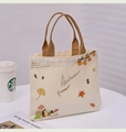 Detail of autumn canvas tote bag with hedgehog and mushroom print on white desk - Autumn Harvest Illustration / Off White