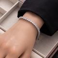 Close-up of silver tennis bracelet with square-cut cubic zirconia on a model wrist - Silver 5*4 Rectangle