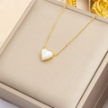 Detail of heart pendant with mother of pearl inlay on gold chain in jewelry box - 3D Shell Heart
