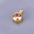 Golden round pendant with champagne crystal birthstone on a grey reflective background - Round Pendant / Champagne