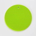 Green circular silicone honeycomb mat with hanging hole shown from top view - Green